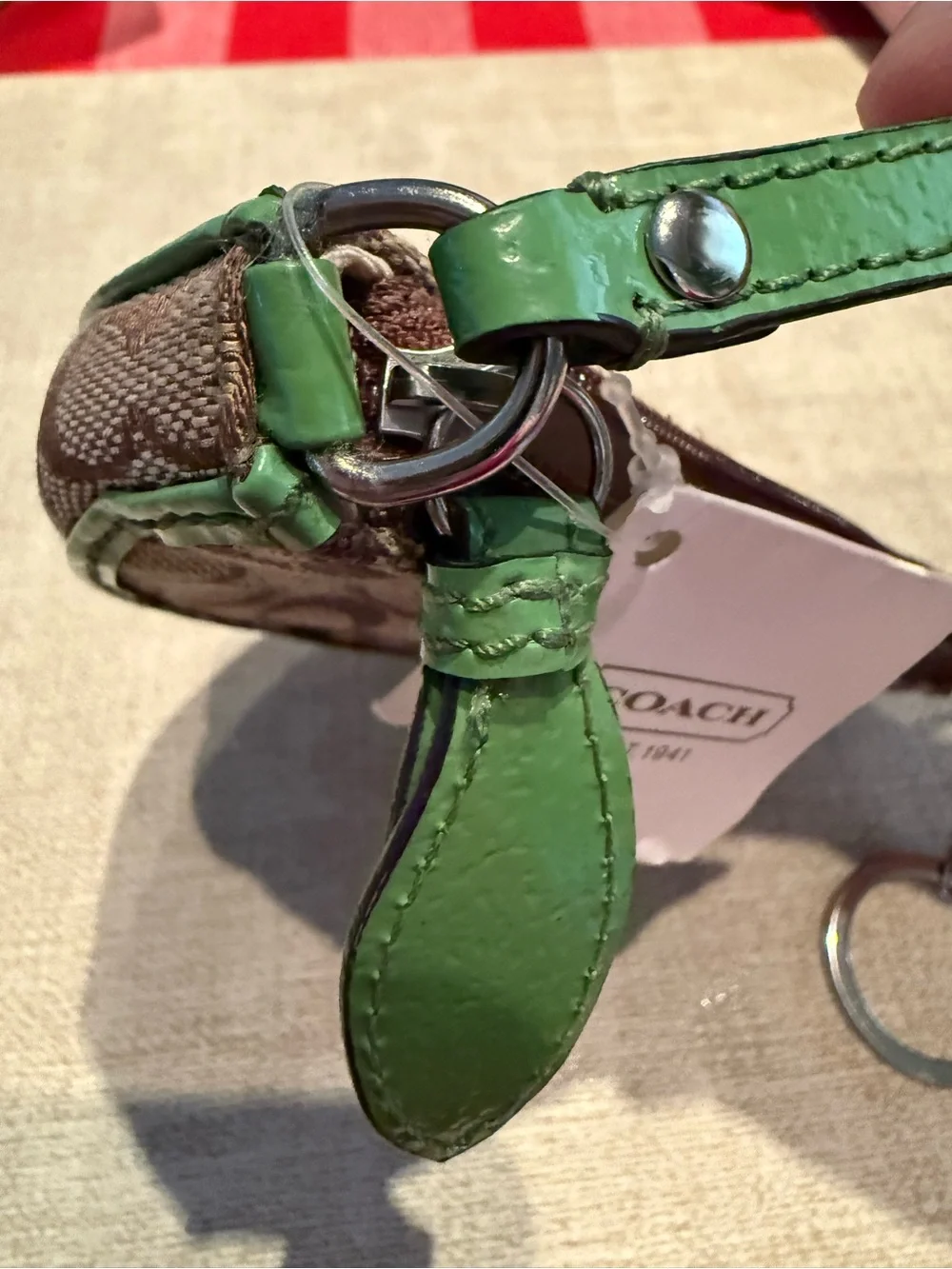 Coach Brown Signature Wristlet with Green Trim and Daisy Motif